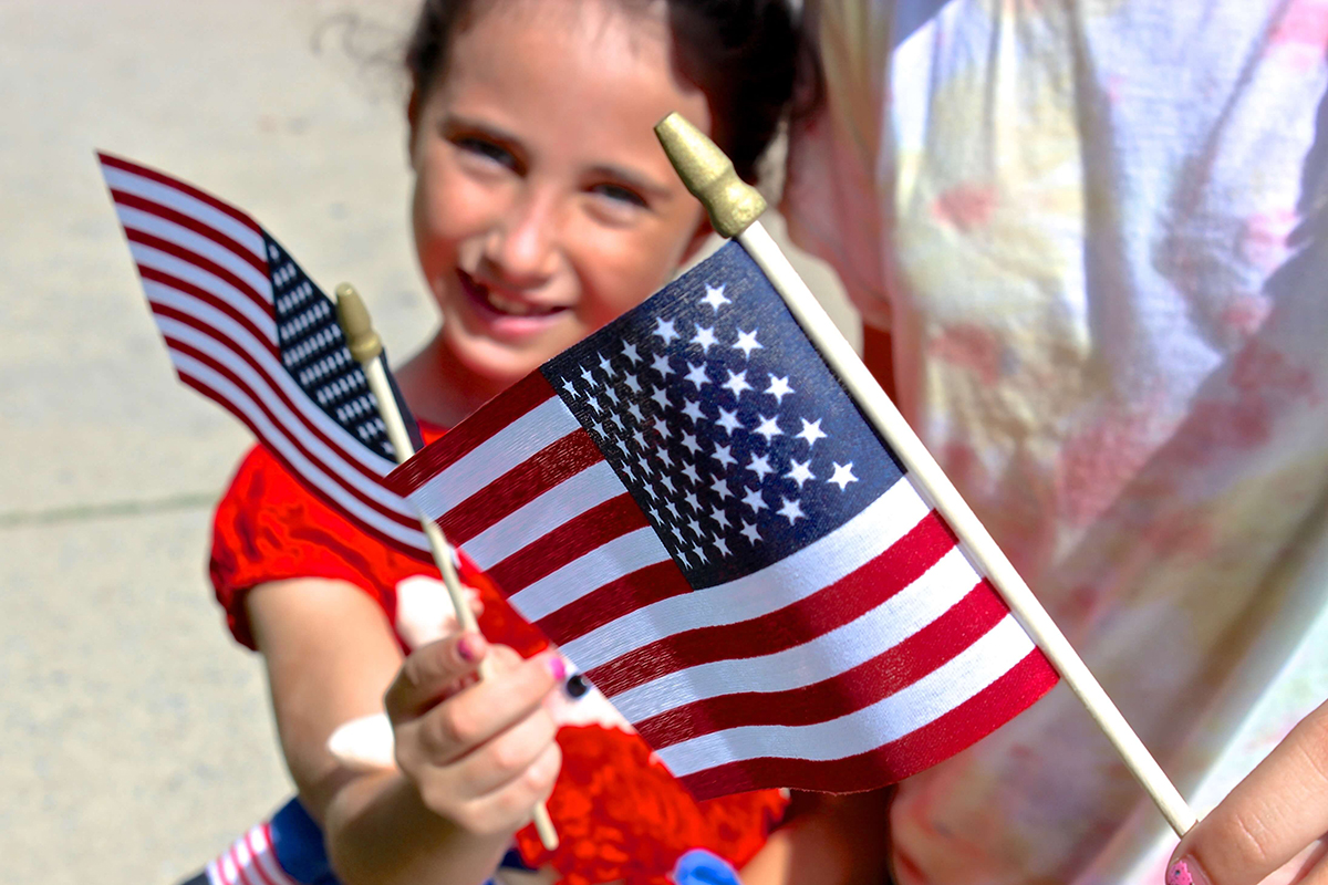 children holding small american flags
