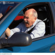 male driver with road rage in blue vehicle