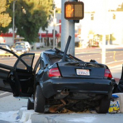 black audi crashed into traffic light pole