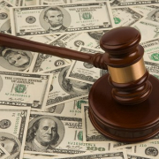 judges gavel on top of a pile of money