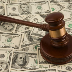 judges gavel on top of a pile of money