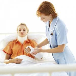 nurse tending to woman in neck brace and arm cast