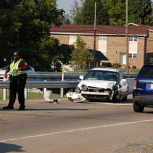 traffic accident involving a white vehicle hitting median