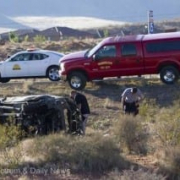 car rolled over on side of road with police assisting